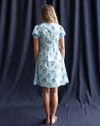 Downeast Bluebell Dress featuring a flowing fabric and floral pattern, displayed on a hanger against a neutral background.