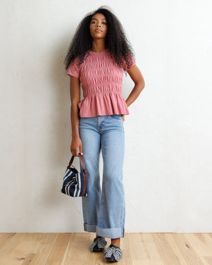 Downeast smocked tee featuring a relaxed fit and short sleeves, styled with casual fabric and detailed smocking at the neckline.
