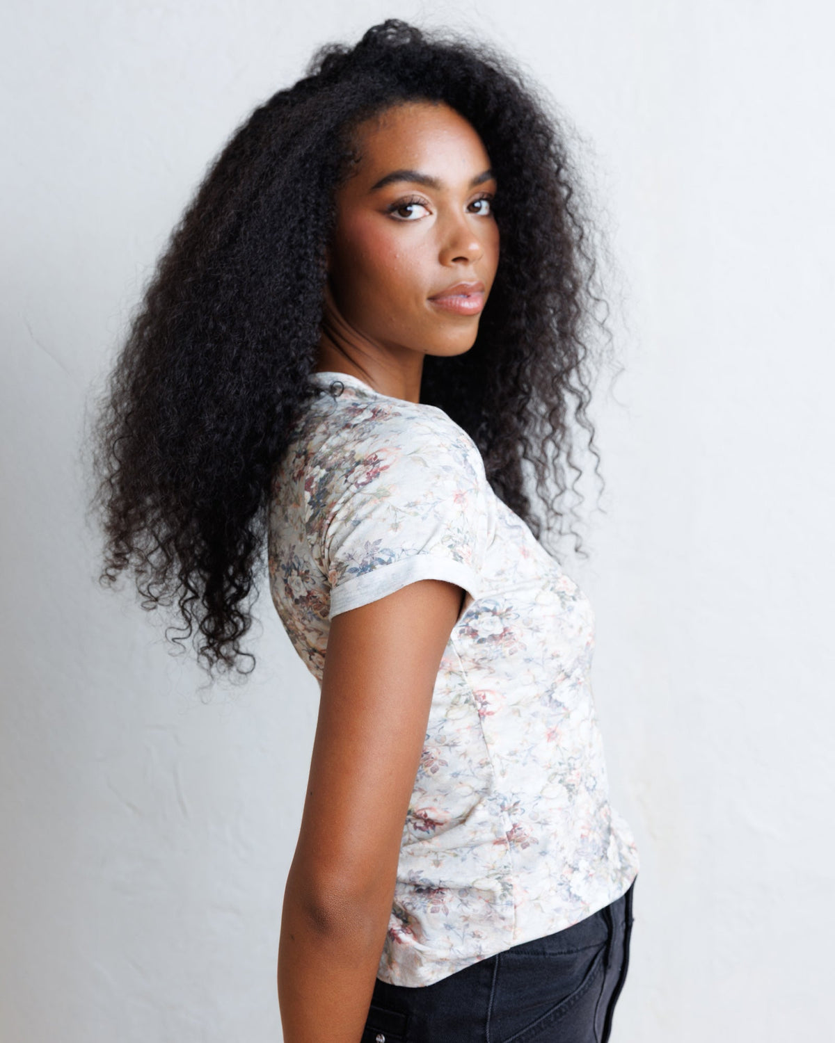 Downeast Go Floral Tee, a casual women's top with a floral pattern and short sleeves, displayed on a hanger.