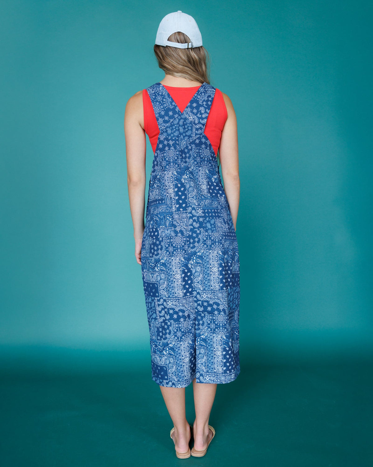 Downeast OOTD overalls dress with adjustable straps and front pockets, worn casually in a relaxed outdoor setting.