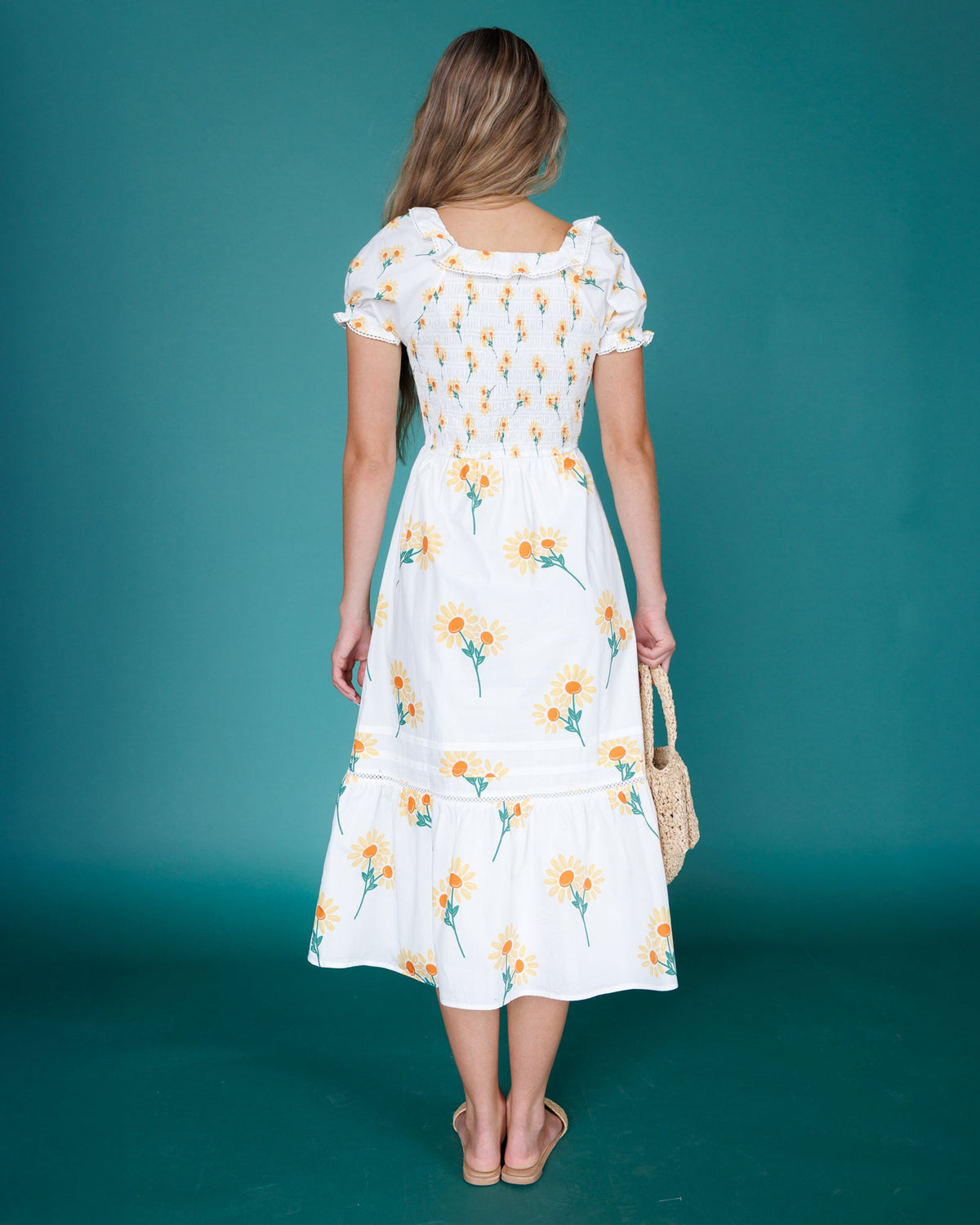 Downeast Arboretum Dress shown on a model, featuring a floral pattern, flowing fabric, and a stylish, casual design.