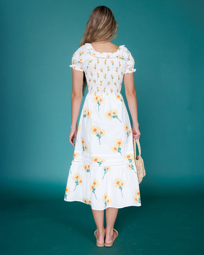 Downeast Arboretum Dress shown on a model, featuring a floral pattern, flowing fabric, and a stylish, casual design.