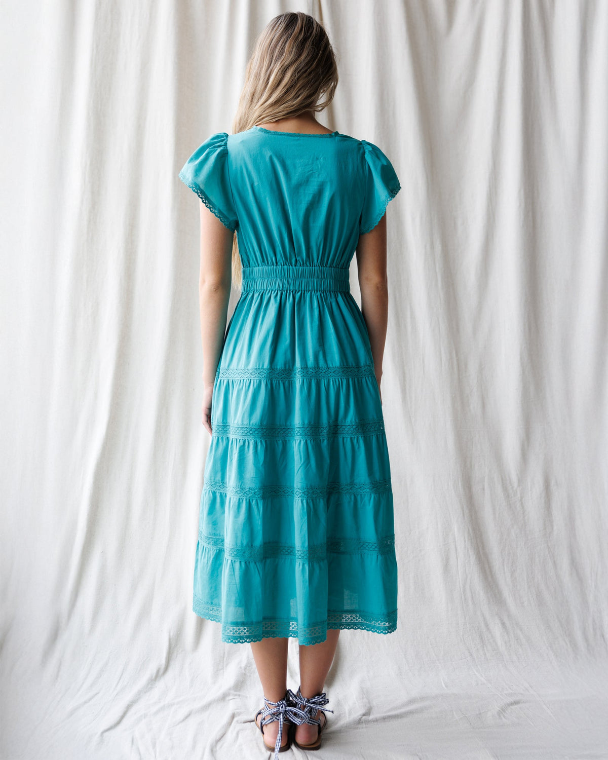 Downeast heirloom dress featuring intricate embroidery and flowing fabric, perfect for special occasions.