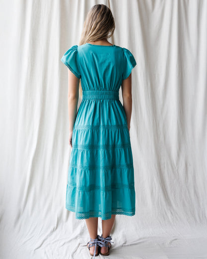 Downeast heirloom dress featuring intricate embroidery and flowing fabric, perfect for special occasions.