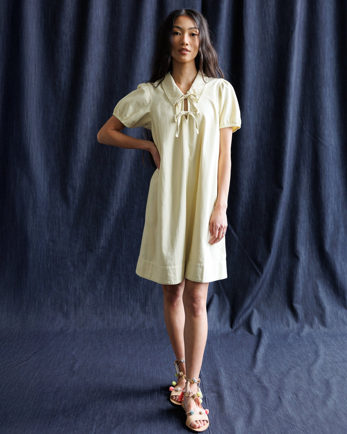 Downeast Demure Denim Dress displayed on a hanger, showcasing classic blue denim fabric and casual style.