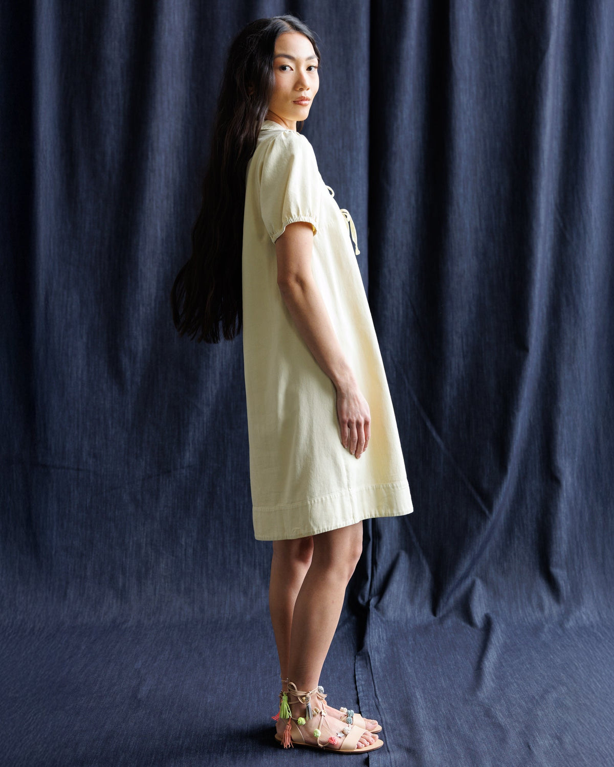 Downeast Demure Denim Dress displayed on a hanger, featuring classic blue denim fabric and a modest, stylish design.