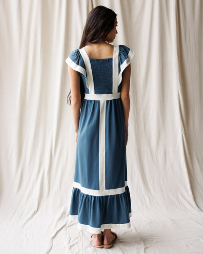 Downeast Block Party Dress shown hanging on a hanger, featuring colorful patterned fabric and a relaxed, casual style.