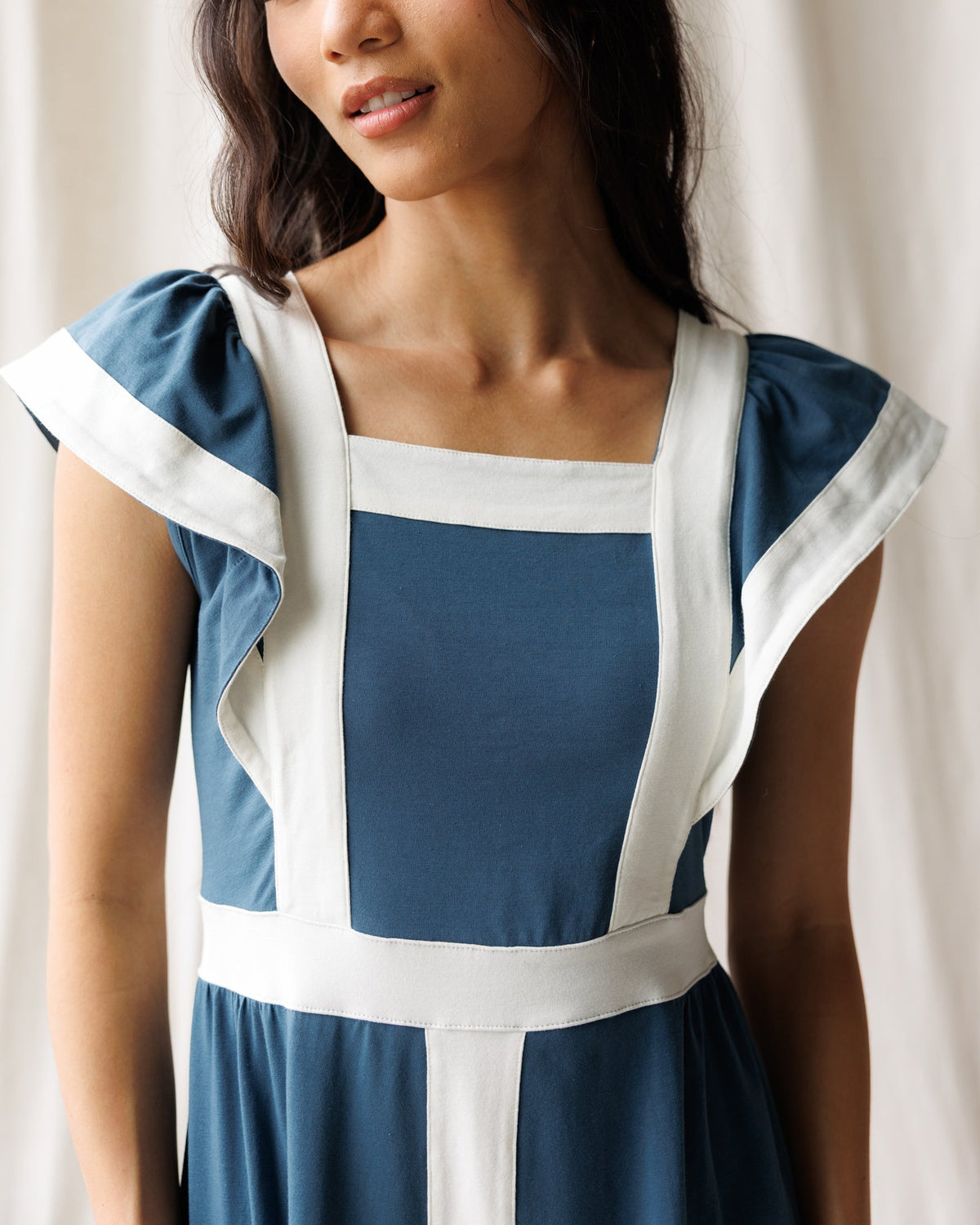 Downeast Block Party Dress, stylish sleeveless dress with colorful pattern, displayed on a mannequin against a neutral background.
