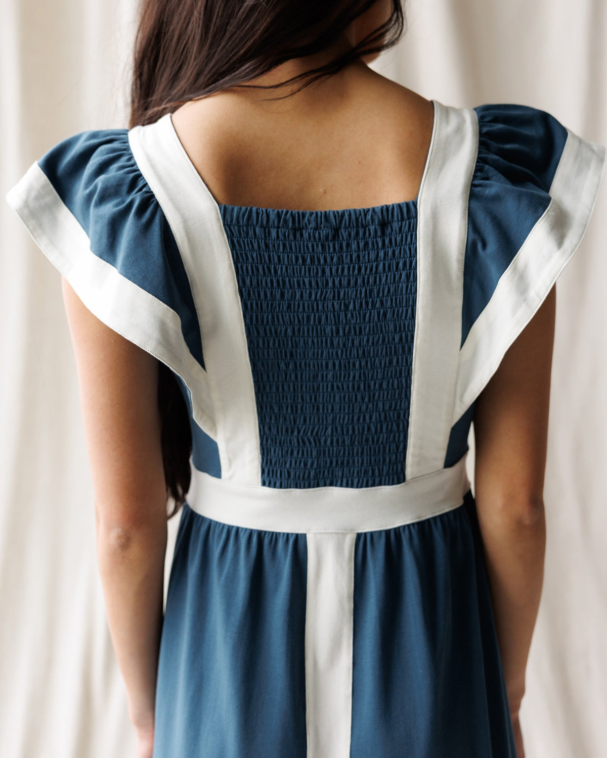 Downeast Block Party Dress displayed on a hanger, featuring a colorful, casual dress with a relaxed fit and stylish design.