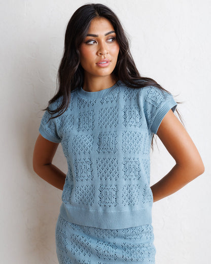 Downeast Frame-Worthy Sweater, cozy knit sweater in neutral tones, displayed on a hanger against a plain background.