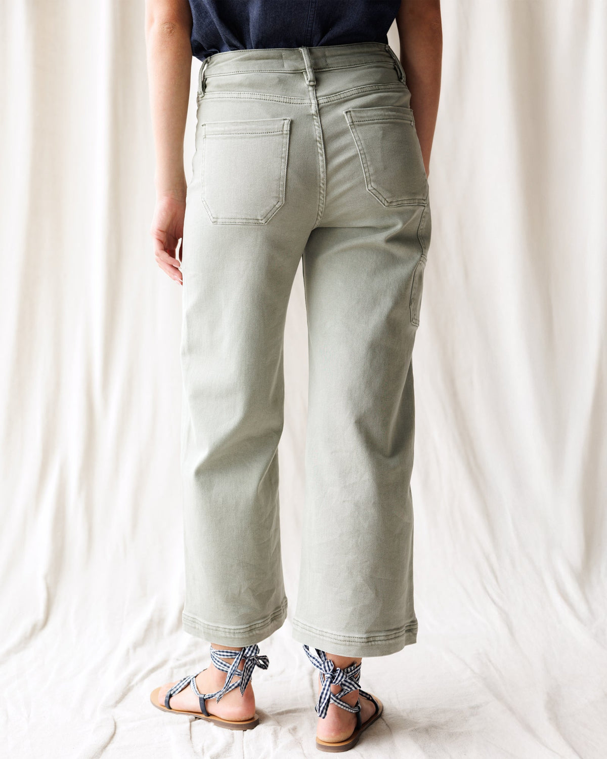 Downeast Super High Wide Cropped Denim Utility Pants displayed on a hanger, showcasing the relaxed fit and distressed details.