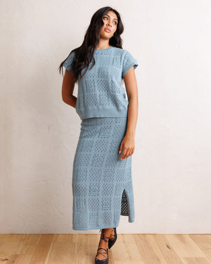 Downeast Frame-Worthy sweater displayed on a hanger, featuring a cozy knit texture and classic design in neutral colors.