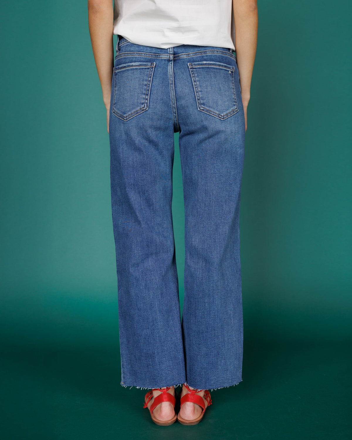 Downeast high rise wide leg denim jeans displayed on a model, showcasing the relaxed fit and classic blue wash.