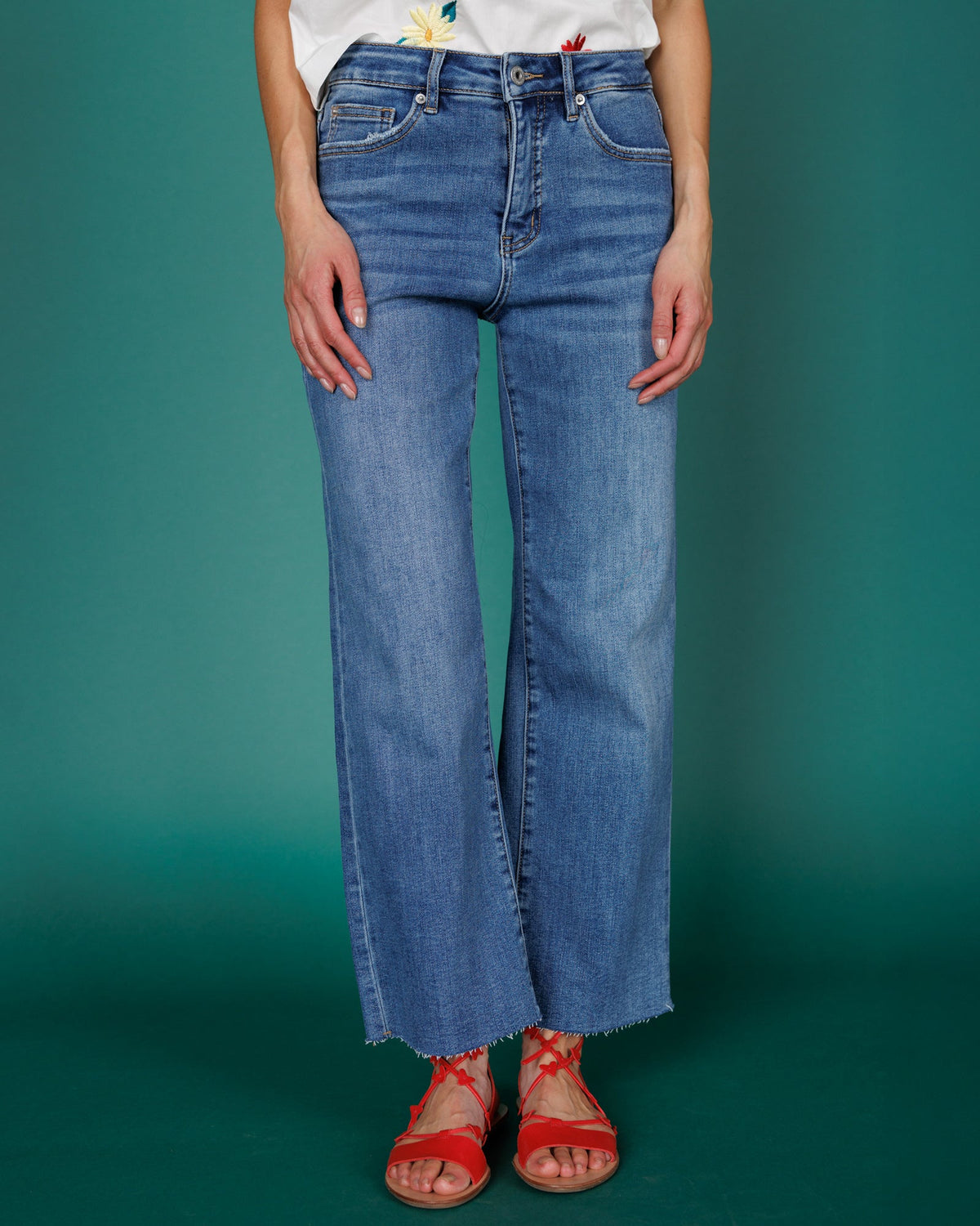 Downeast high rise wide leg denim jeans displayed on a hanger, showcasing the relaxed fit and classic blue denim fabric.