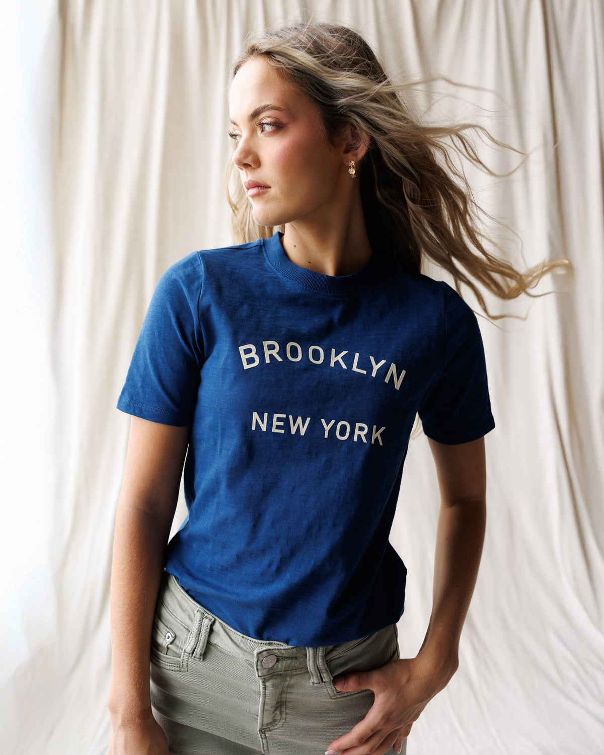 Downeast Brooklyn Tee in soft fabric, featuring a classic fit and crew neckline, displayed on a hanger.