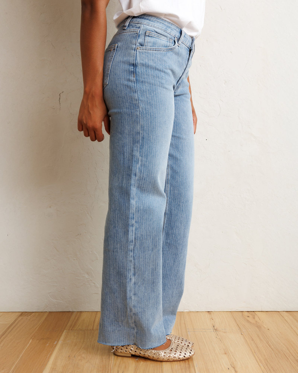 Downeast mid-rise wide stripe denim jeans shown on a hanger, featuring a classic fit with bold stripe pattern and traditional denim texture.