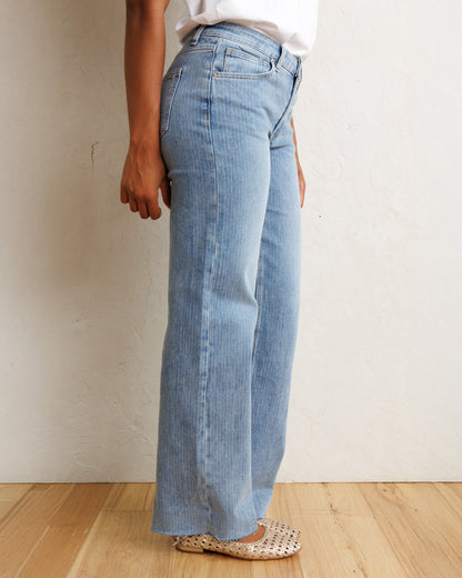Downeast mid-rise wide stripe denim jeans shown on a hanger, featuring a classic fit with bold stripe pattern and traditional denim texture.