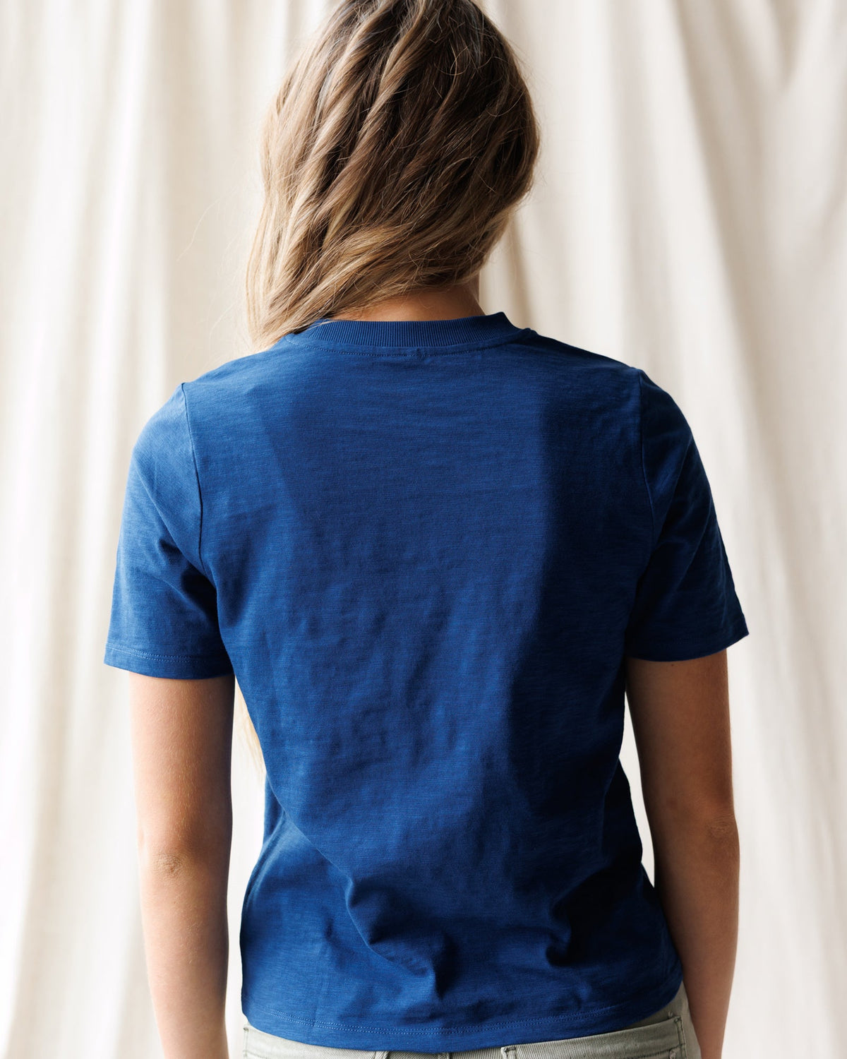 Downeast Brooklyn Tee, casual cotton tops, featuring a relaxed fit and short sleeves, displayed on a hanger.
