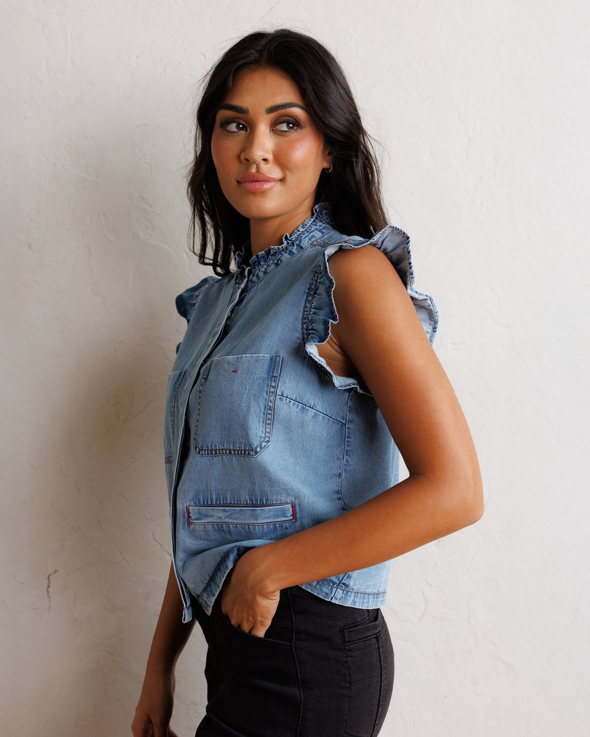 Downeast day-to-day denim vest, stylish outerwear with front pockets and button closure, displayed on a neutral background.