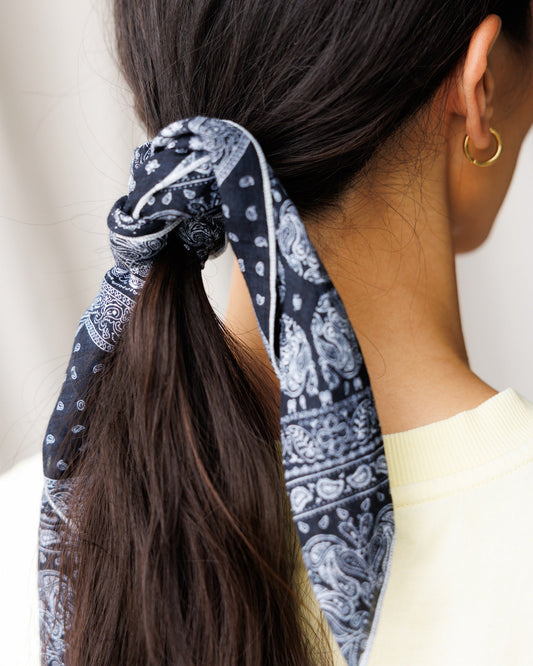 Downeast The Daily Scarf in soft fabric, shown draped over a neutral background, highlighting its cozy, versatile design.