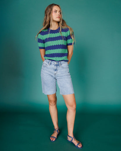 Downeast Tropez sweater displayed on a hanger showing its knit texture and classic crewneck design.