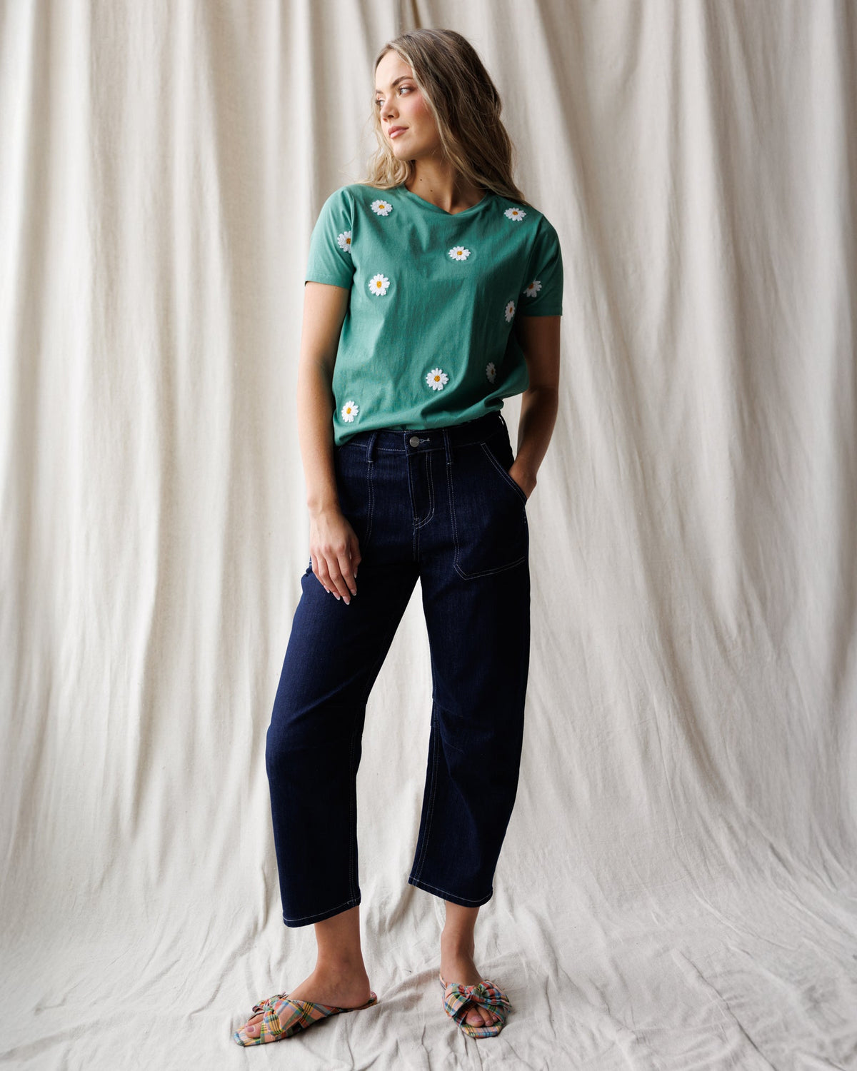 Downeast Pretty Petals Tee, a casual women's top with floral print, displayed on a hanger in a retail setting.