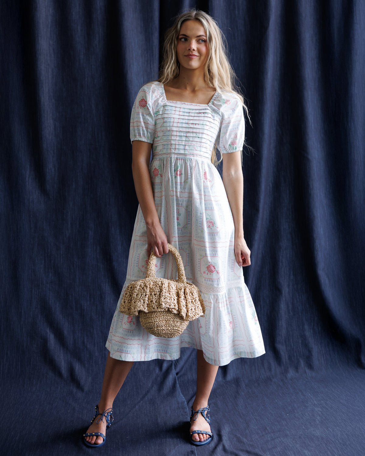 Downeast cross stitch crochet dress displayed on a hanger, showcasing intricate pattern and lightweight fabric.
