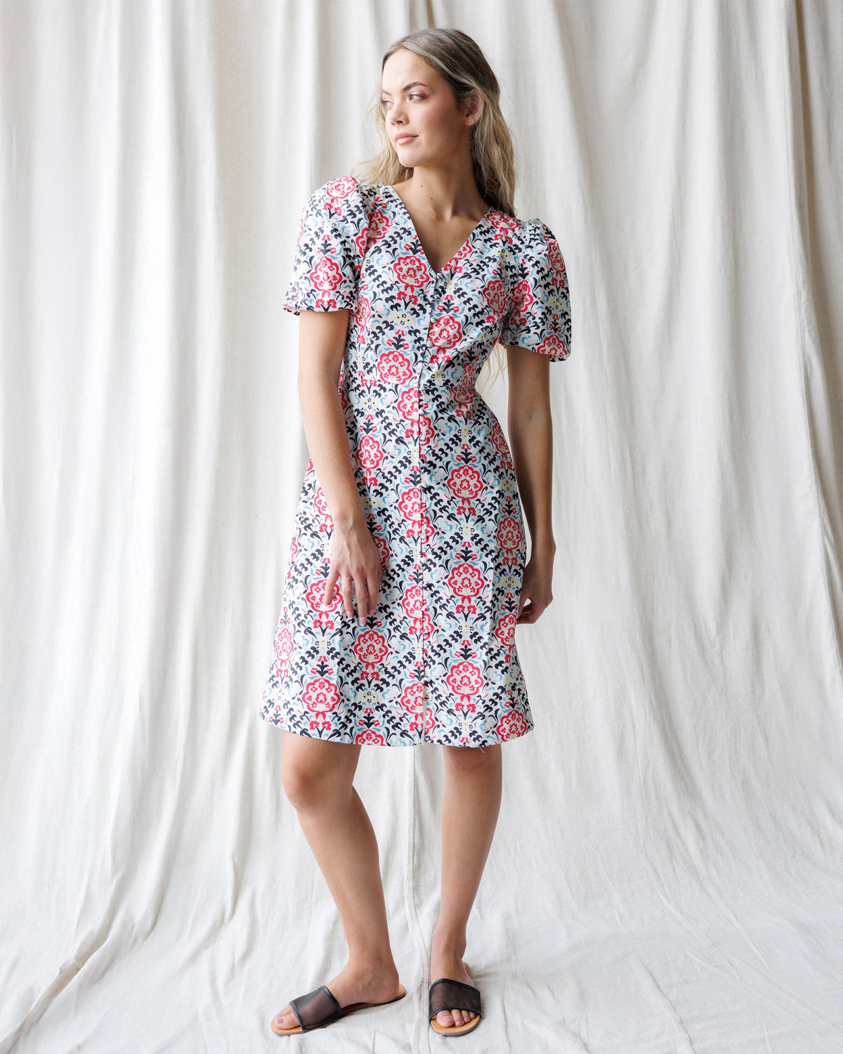 Downeast Capri dress displayed on a hanger, showcasing its lightweight fabric and casual summer style.