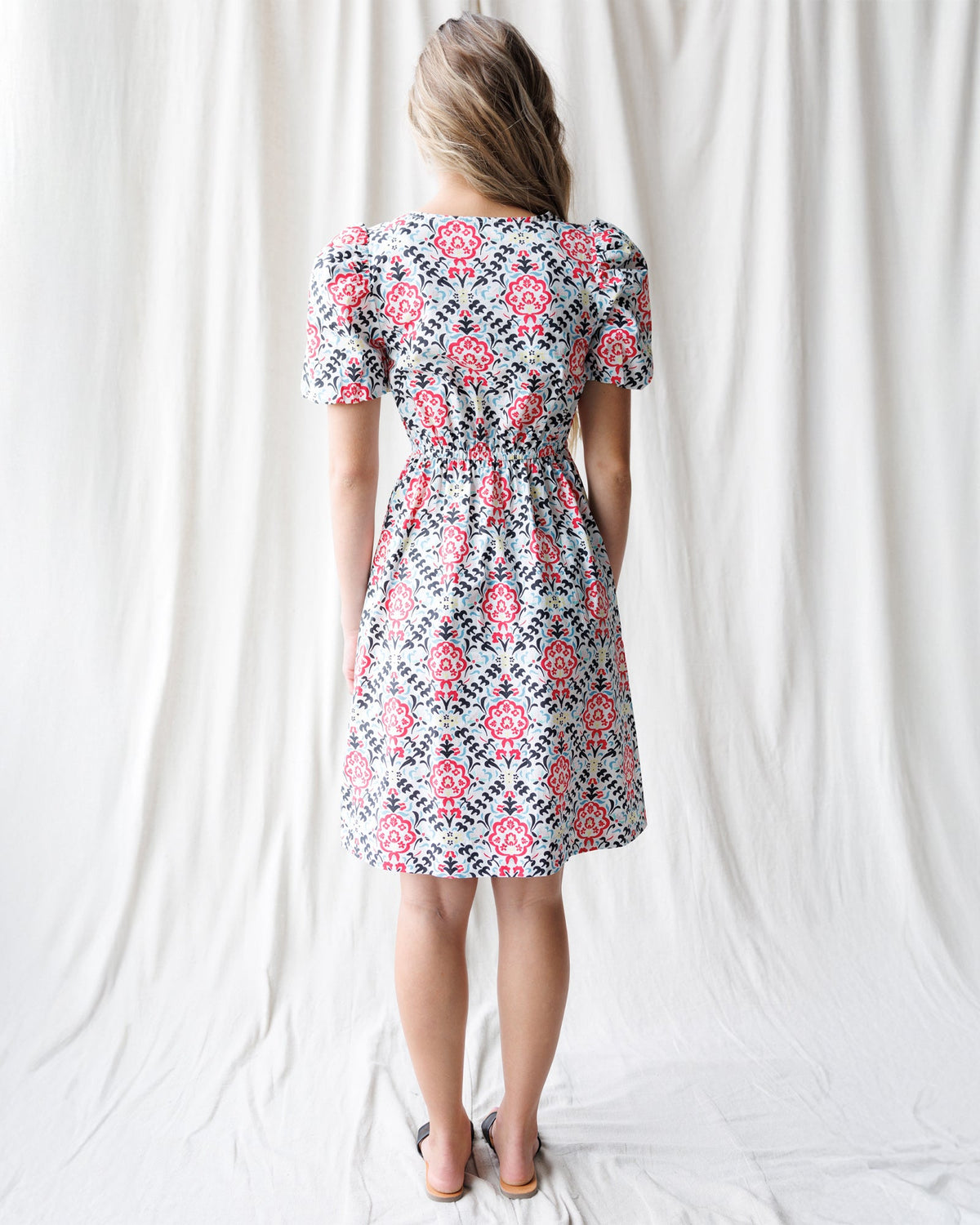 Downeast Capri Dress displayed on a hanger, featuring a flowy, casual dress with a sleeveless design and lightweight fabric.