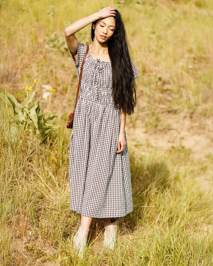 Downeast Maybelle Dress featuring a floral print, V-neckline, and short sleeves, displayed on a hanger against a neutral background.