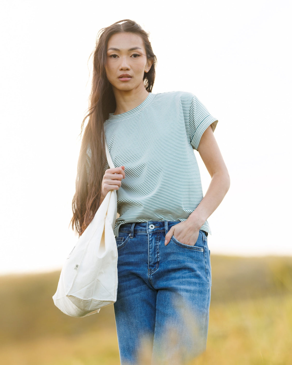 Downeast Fundamental Tee, a casual tops style in soft fabric, shown in a neutral color on a hanger.