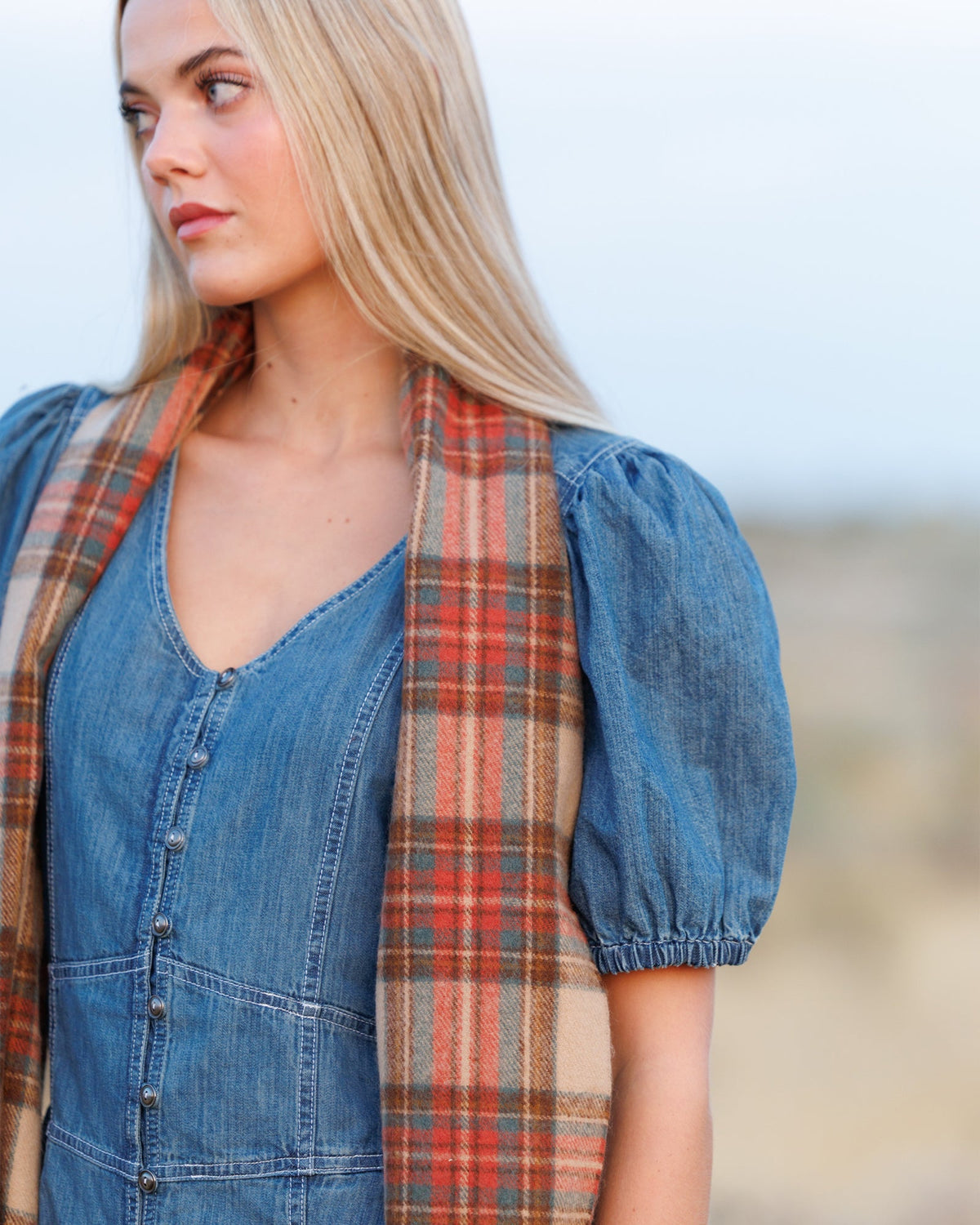 Downeast Golden Hour Scarf featuring soft fabric with a warm, golden-toned pattern, draped elegantly for a cozy look.