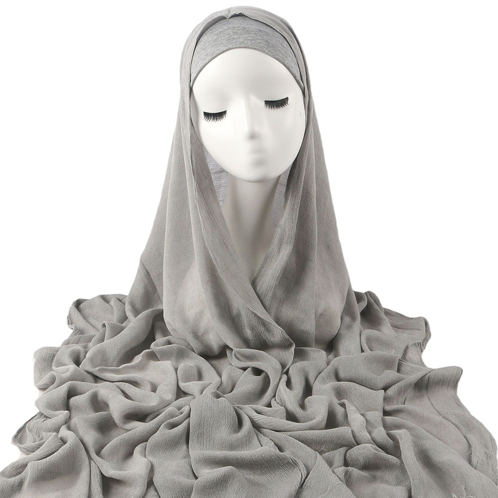 Women's solid-color pleated faux hijab displayed flat, featuring a textured pleated design