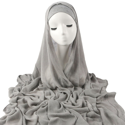 Women's solid-color pleated faux hijab displayed flat, featuring a textured pleated design