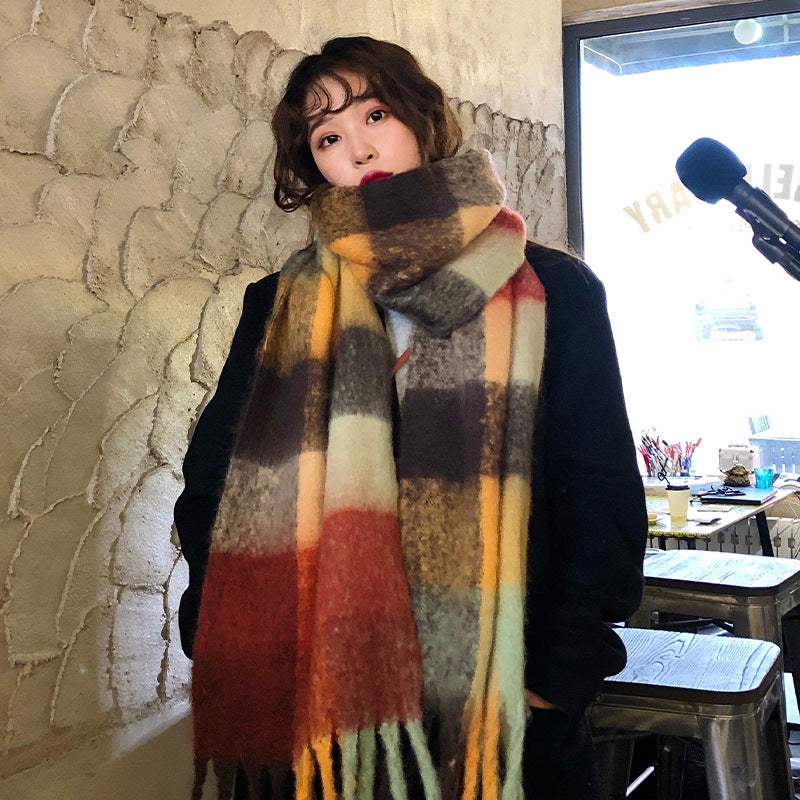 Plaid thickened warm cashmere-look scarf in soft neutral tones, draped to show its textured weave and fringed edges