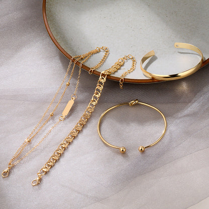 Alloy chain and round-ring bracelet set, close-up view of linked metallic bracelets