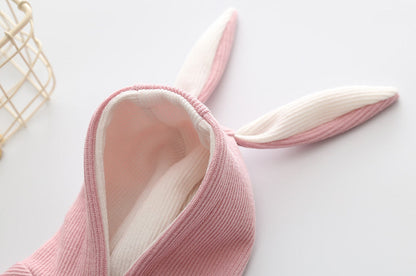 Small dog knitted sweater with rabbit ears costume in soft pink fabric