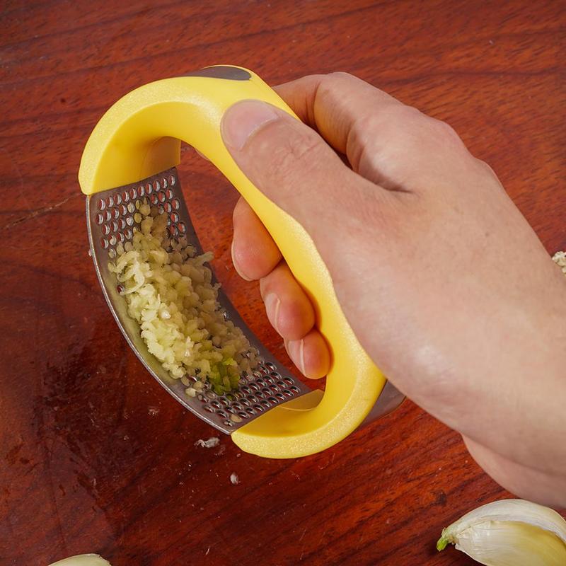 Stainless steel garlic masher and manual garlic press with curved handle for kitchen use