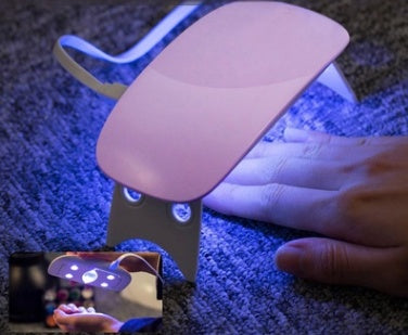 Portable 6W USB LED light therapy nail lamp in white and pink with compact design