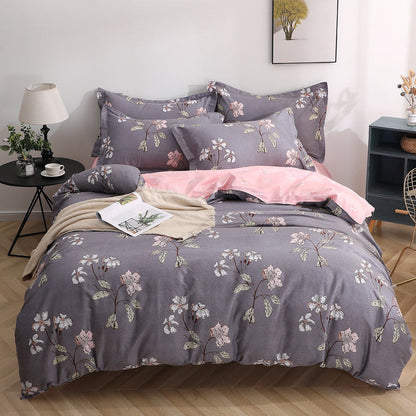 Four-piece cotton bedding set in soft home textile fabric, featuring coordinated sheets and pillowcases