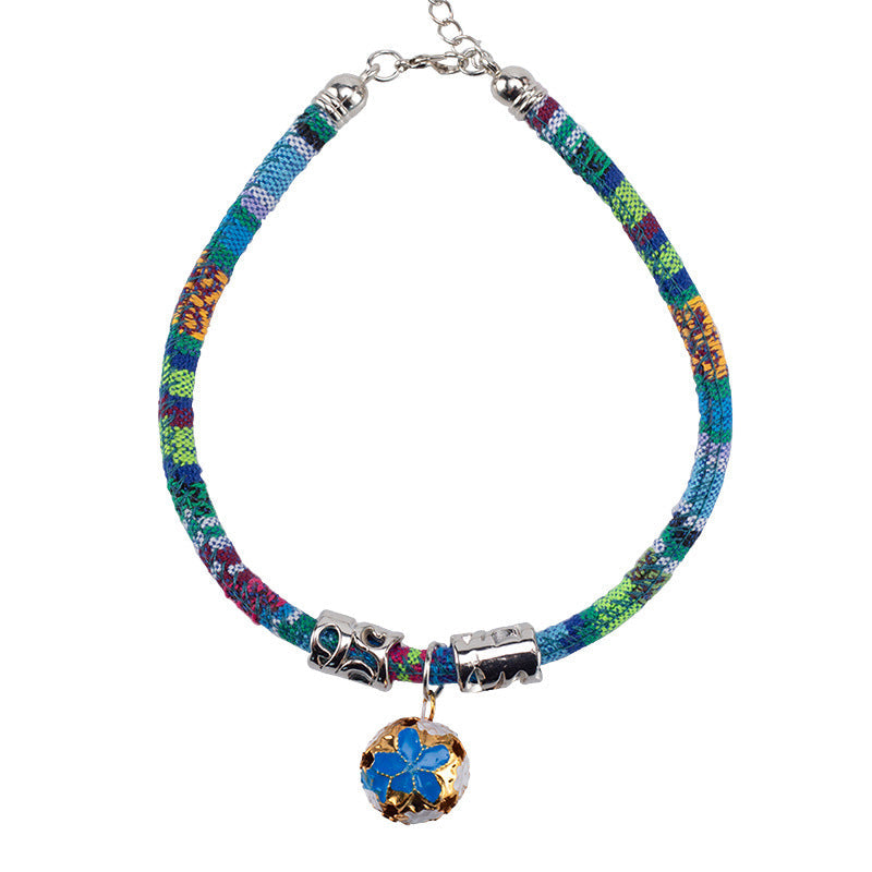 Ethnic style bell collar with decorative bell detail, close-up view