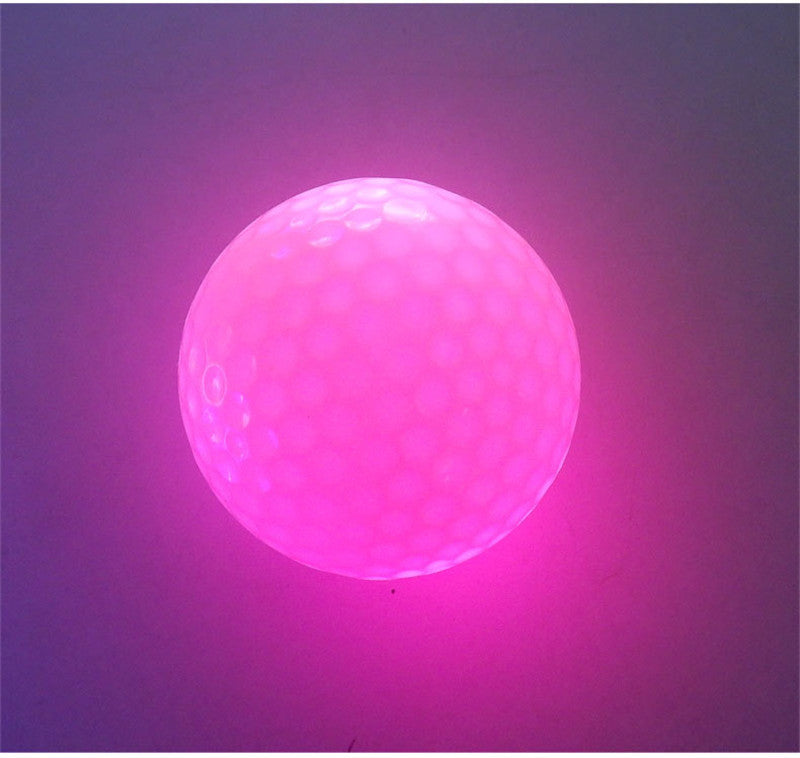 Flashing LED golf ball for nighttime play, shown with illuminated colorful lights