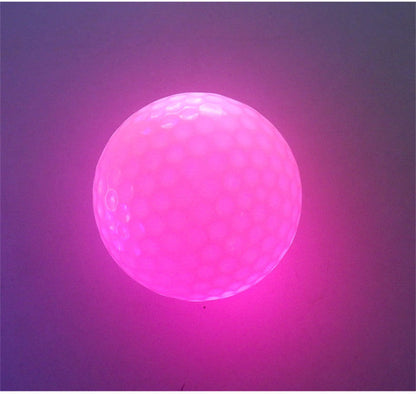 Flashing LED golf ball for nighttime play, shown with illuminated colorful lights