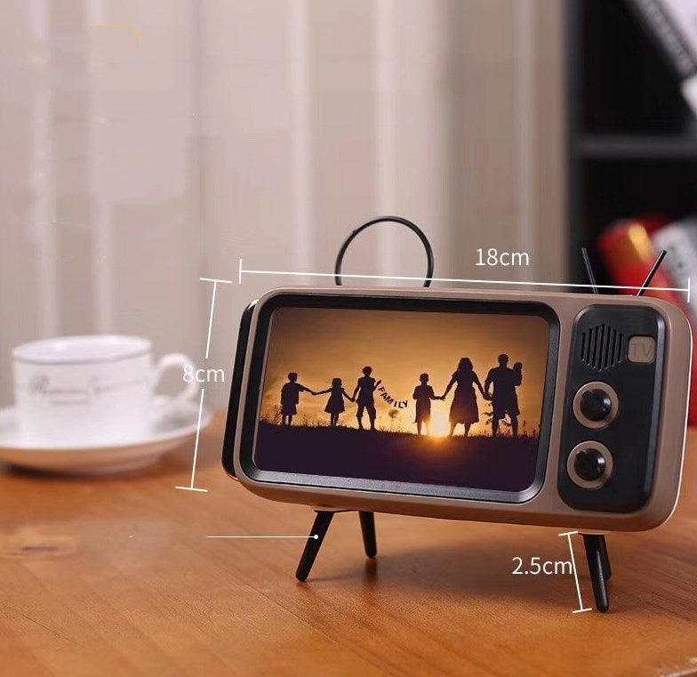 Retro TV mini portable audio player with vintage television design, compact black body and visible speaker grille