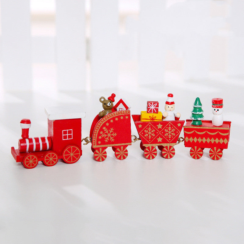 Wooden Christmas train decoration with festive red and green details 񟿿