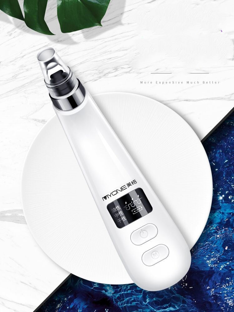 Electric blackhead remover in black, handheld skincare device with suction nozzle