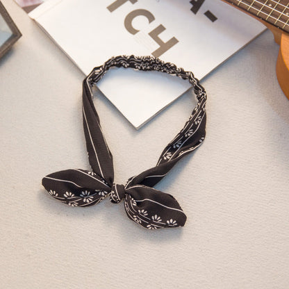 Big bow tie bunny ears headband with playful rabbit ears and oversized bow detail