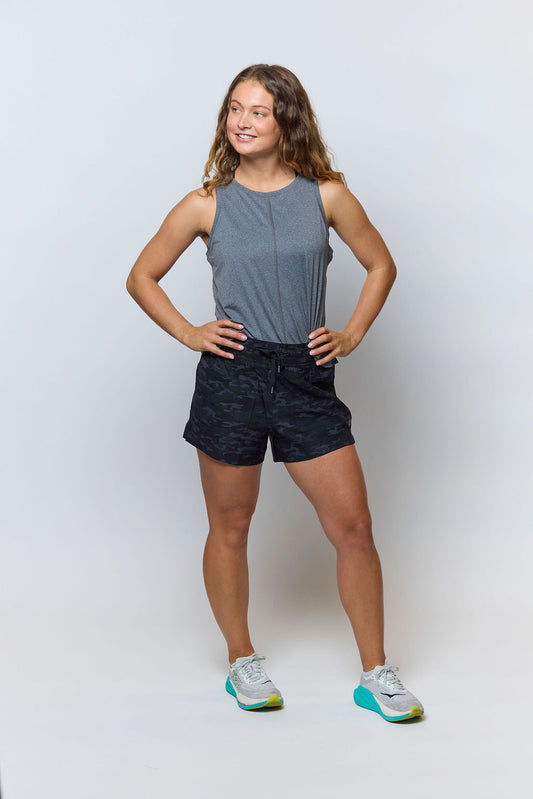 Goal Five boxy crop tank top displayed on a model, featuring a relaxed fit and sleeveless design perfect for casual wear.