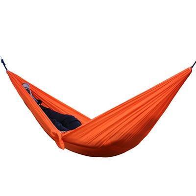 Portable nylon parachute outdoor double backpacking hammock shown suspended between trees