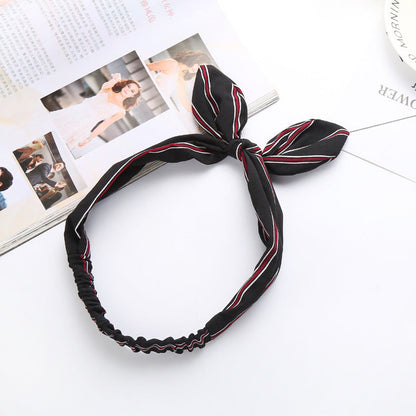 Big bow tie bunny ears headband with oversized bow and soft rabbit ears on a hair accessory band